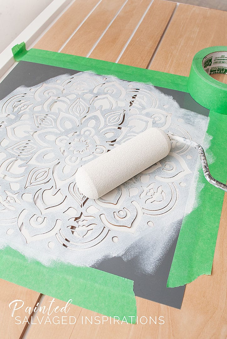 Rolling Paint onto Mandala Stencil For Dresser Makeover